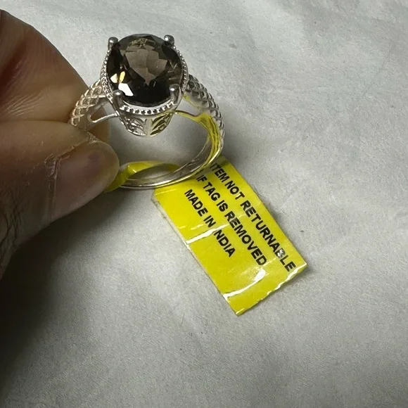 This is a sterling silver ring featuring a smoky quartz gemstone